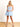 Model is wearing a baby blue strapless cutout romper.