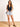 Model is wearing a black sleeveless surplice bodysuit.