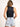 Model is wearing a black sleeveless surplice bodysuit.