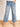 Model is wearing medium wash mid rise cropped wide leg jeans.