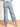 Model is wearing medium wash mid rise cropped wide leg jeans.