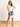 Model is wearing a white sleeveless surplice bodysuit.