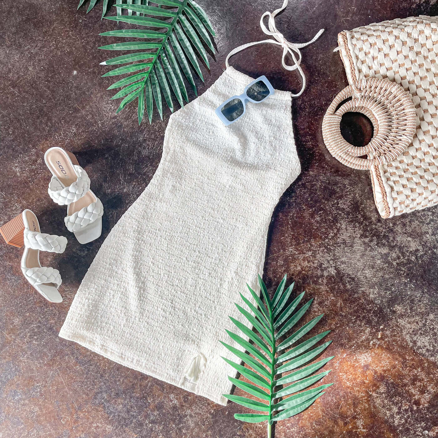 woman’s cute vacation outfit with beachy accessories