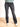 Model is wearing washed black flare leg jeans with raw cut hem and front button and zipper closure