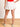 Model is wearing a white ruffled wrap front mini skort.