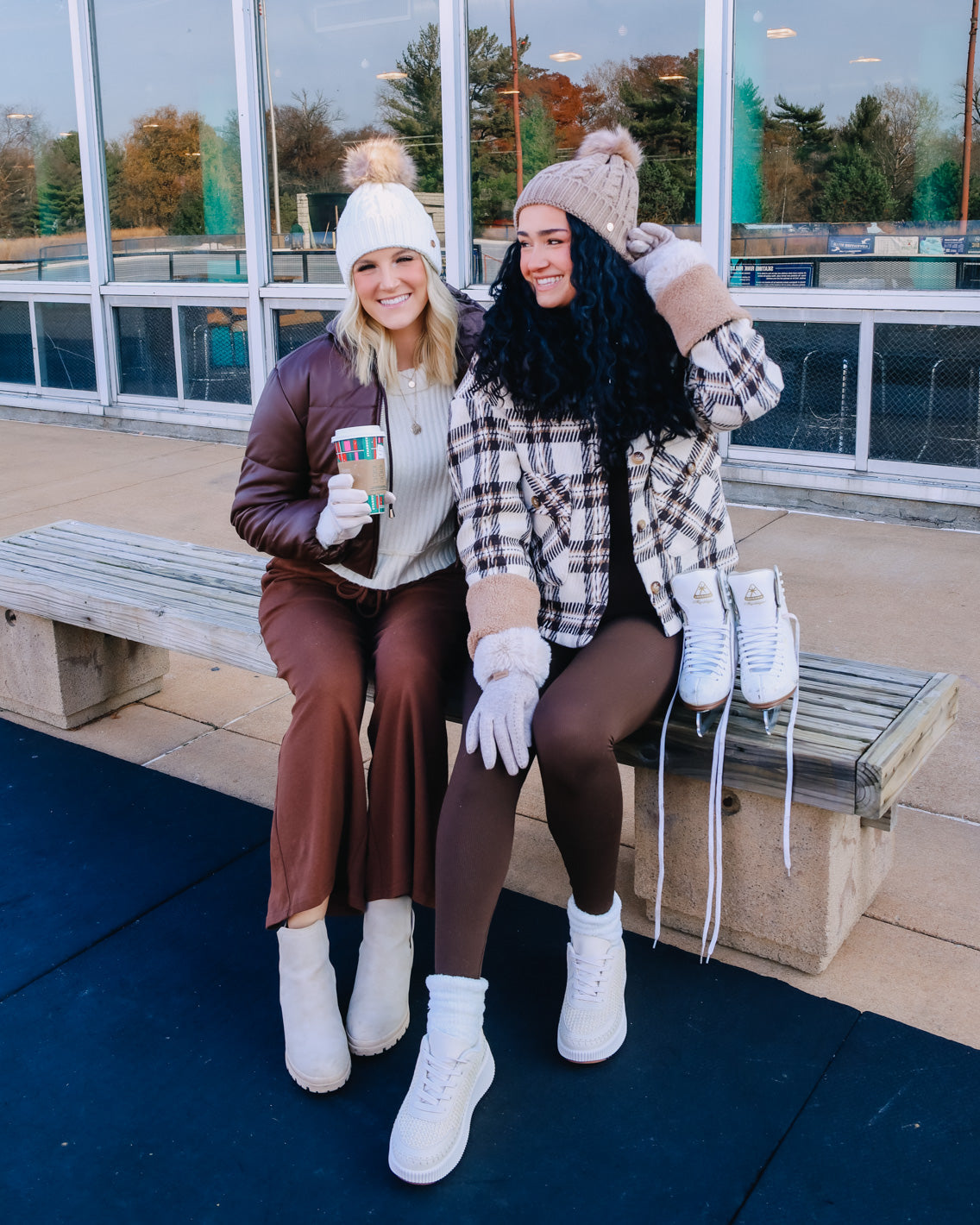 Models wearing brown and cream loungewear with coats and winter accessories.