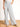 Model is wearing dove grey wide leg pants.