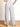 Model is wearing dove grey wide leg pants.