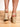 Model is wearing black and ivory crochet trim wedge sandals.