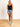 Model is wearing a long black seamless u-neck tank.