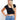 Model is wearing a black cap sleeve crop top. 
