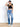 Model is wearing a black cap sleeve crop top.