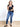 Model is wearing a black v-neck nikibiki top.