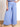 Model is wearing lavender wide leg pants with elastic waistband.