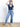 Model is wearing a blue short sleeve v-neck top.