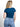 Model is wearing a blue short sleeve v-neck top.