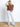 Model is wearing a brown cable knit sweater vest.