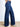 Model is wearing dark wash denim jeans.