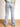 Model wearing light wash, distressed, baggy jeans.