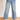 Model is wearing medium wash mid rise cropped wide leg jeans.