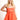 Model is wearing an orange strapless cutout romper.