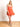 Model is wearing an orange strapless cutout romper.