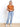 Model is wearing a burnt orange knit top. 