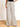 Model is wearing cream/black stripe linen pants.