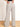 Model is wearing cream/black stripe linen pants.