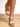 Model is wearing tan crochet trim wedge sandals.