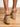 Model is wearing tan crochet trim wedge sandals.