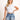 Model is wearing a white nikibiki ribbed short sleeve baby tee.
