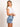 Model is wearing a white nikibiki ribbed short sleeve baby tee.