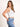 Model is wearing a white high neck crop tank.