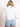 Model wearing a cropped white denim jacket.
